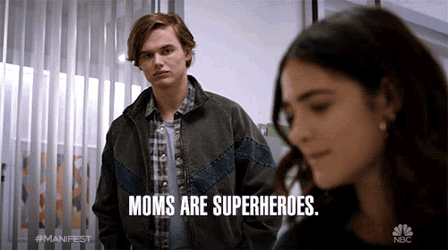 a man standing next to a woman with the words moms are superheroes on the bottom