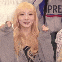 a woman with blonde hair is wearing a gray sweatshirt with the word pre on it .