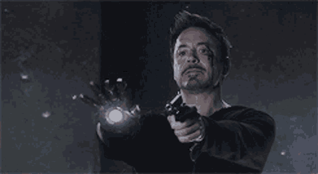 a man is pointing a gun at something in the air