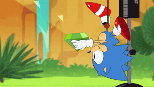 a cartoon of sonic the hedgehog hanging upside down holding a green emerald