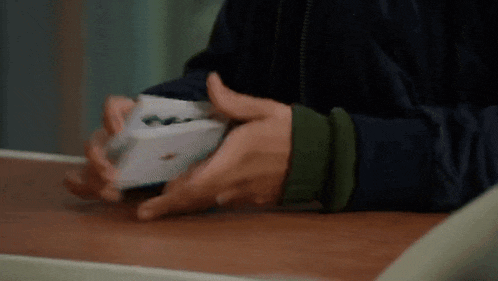 a close up of a person 's hands holding a piece of paper .