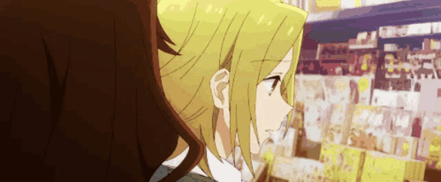 a couple of anime girls are standing next to each other in a store looking at books .