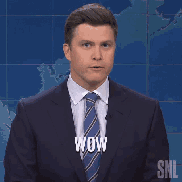 a man in a suit and tie with wow written on his face