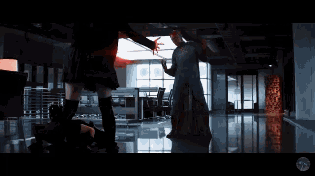 a man in a superhero costume is standing next to a woman in a black skirt