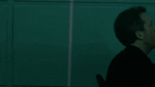 a silhouette of a person 's head is visible in the dark