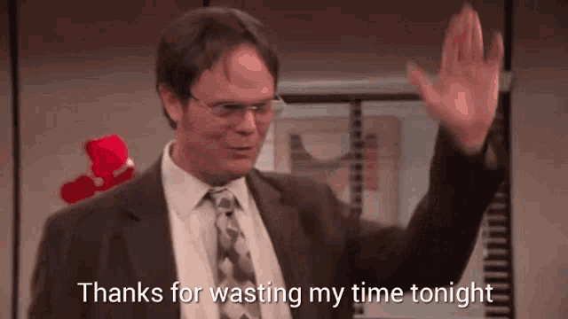 a man in a suit and tie is waving his hand and says thanks for wasting my time tonight