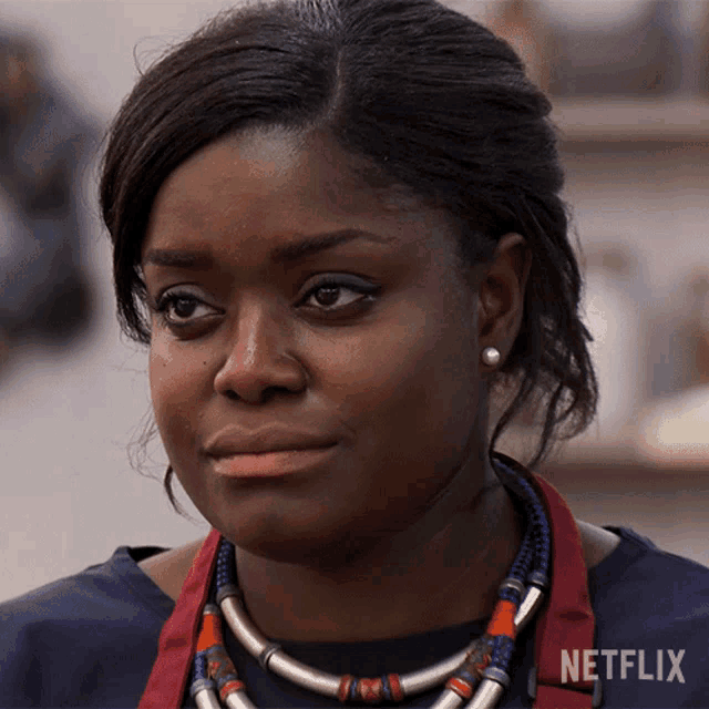a close up of a woman 's face with a netflix logo on the bottom right