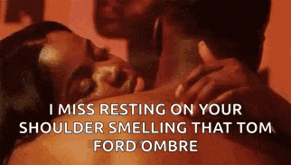 a woman is laying on a man 's shoulder while a man kisses her on the neck .