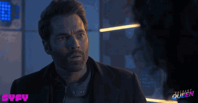 a man in a suit is looking at a woman in a room with the words vagabond queen written on the bottom