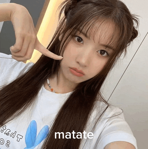 a girl with a white shirt that says matate