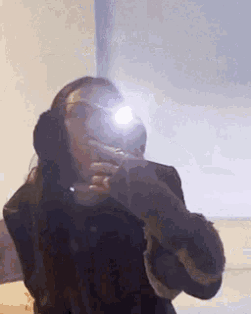 a woman is taking a selfie in a mirror while wearing headphones .