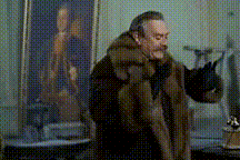 a man in a fur coat stands in front of a painting of a man