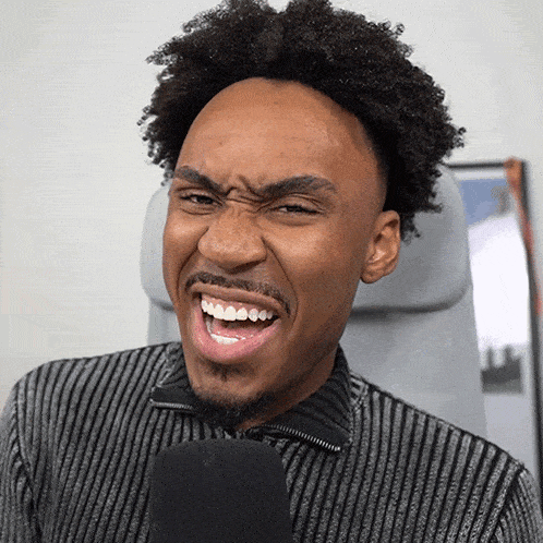 a man with a striped shirt is making a funny face