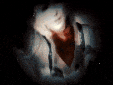 a blurry picture of a person 's face with a red scarf around their neck