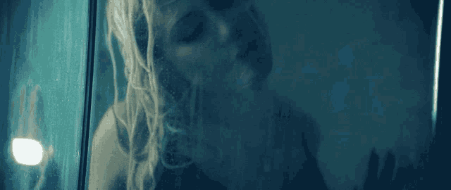 a close up of a woman behind a glass door