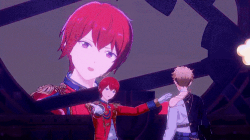 a man with red hair is standing in front of a large screen