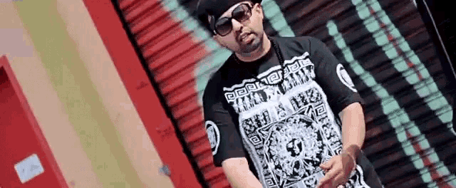 a man wearing sunglasses and a t-shirt that says ' army ' on it