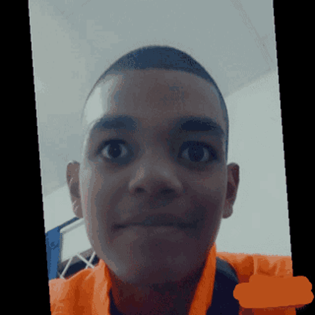 a close up of a person 's face with an orange circle in the middle