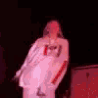 a man is standing in front of a microphone on a stage .