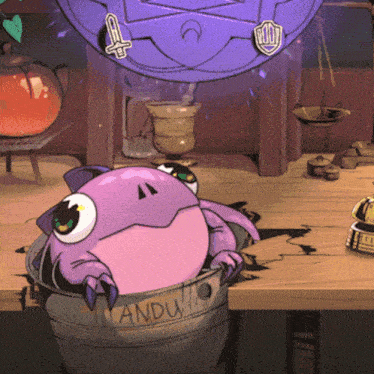 a purple frog sits in a bucket labeled anduito