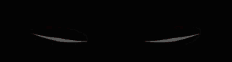 a pair of red eyes with a white outline on a black background