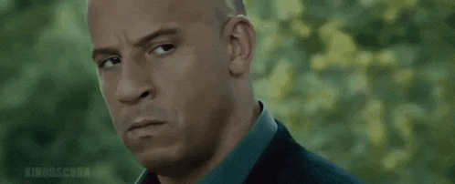 a close up of a man 's face with a serious expression .