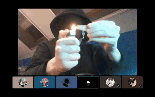 a man in a hat is lighting a cigarette in front of a group of people