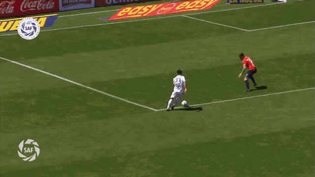 a soccer game is being played in front of a banner that says pandilla toyota