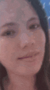 a blurry picture of a woman 's face behind a curtain with numbers on it