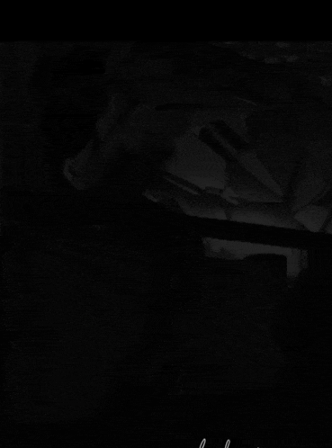 a black and white photo of a man talking on a cellphone
