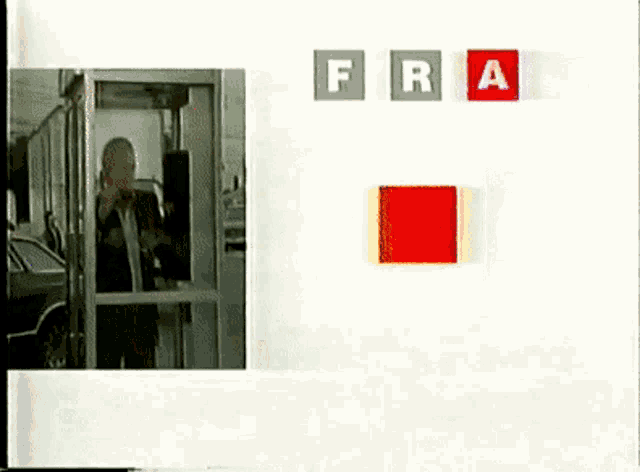 a man standing in front of a sign that says fra