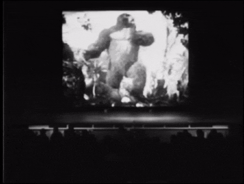 a black and white photo of a giant gorilla