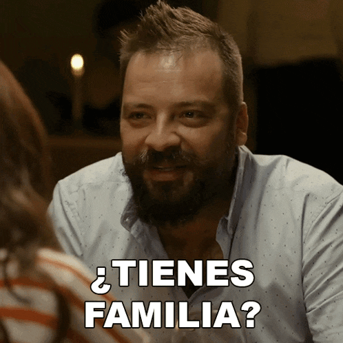 a man with a beard says " tienes familia " in white letters