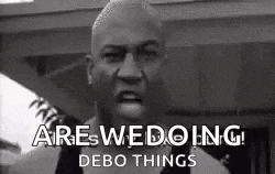 a black and white photo of a man making a funny face and saying `` are we doing debo things '' .