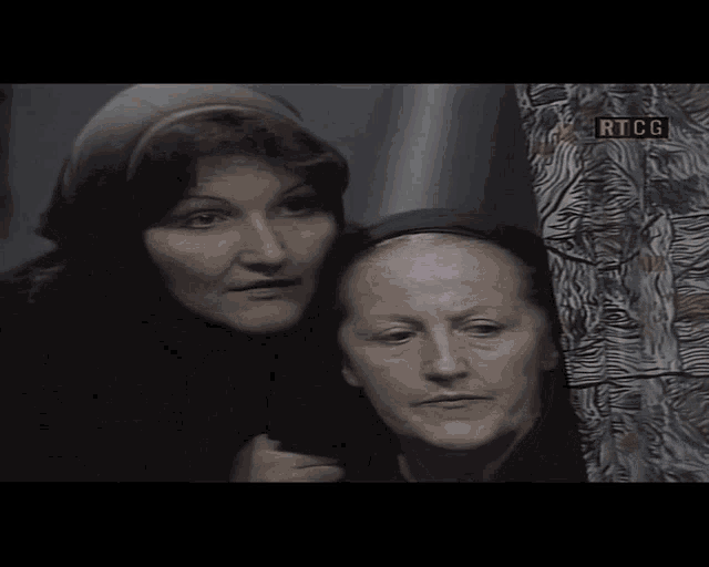 two women are standing next to each other with rtcg written on the bottom right