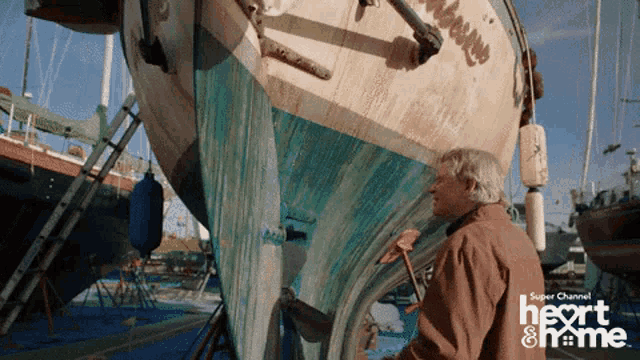 a man standing in front of a boat with the words super channel heart & home written on the bottom