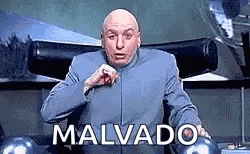 a bald man in a blue suit is sitting in a chair with the word malvado written on it .
