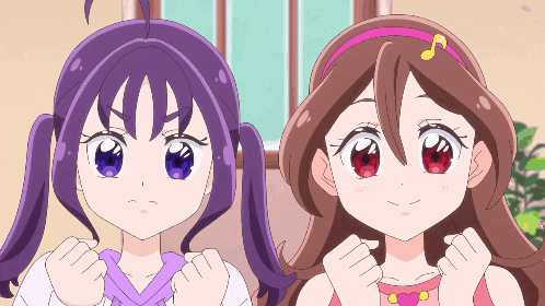 two anime girls are standing next to each other with their fists up