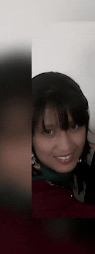 a close up of a woman 's face with a red shirt on