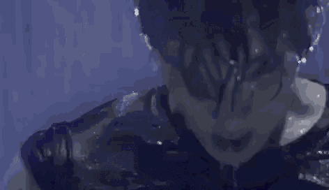 a close up of a person 's face with water coming out of his mouth .