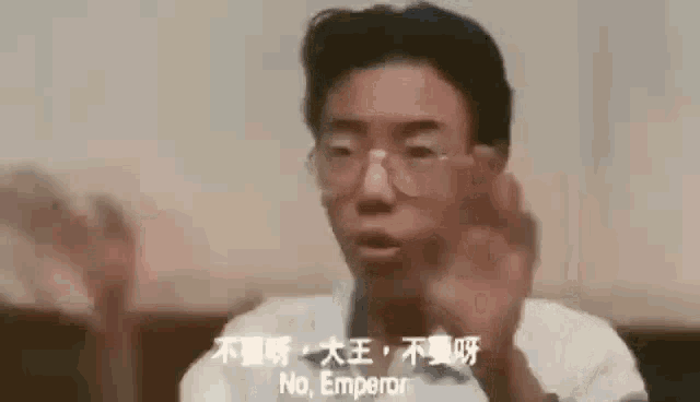 a man wearing glasses is making a funny face and saying `` no emperor '' in a foreign language .