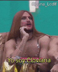 a man with long hair and a beard is sitting on a couch and saying yo soy cloviana