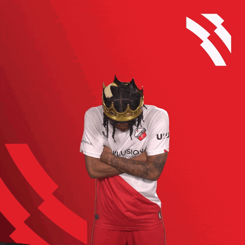 a soccer player wearing a crown and a shirt that says uc