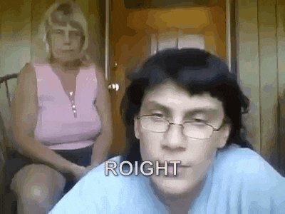 a woman is sitting in a chair behind a man wearing glasses and the word roight is written on his face .