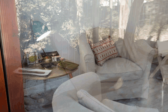 a chair with a pillow on it sits next to a table