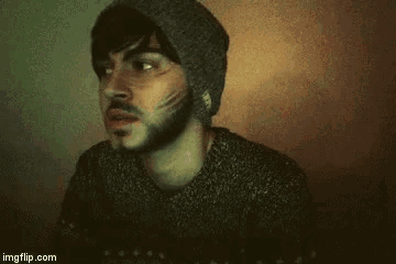 a man with a beard wearing a hat and sweater is smiling with the words ha ! no .
