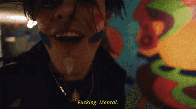 a close up of a person 's face with the words " fucking mental " on the bottom right