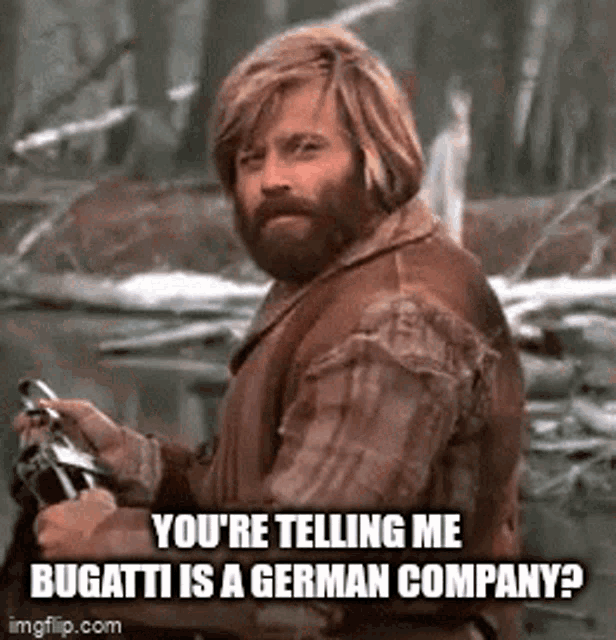 a man with a beard is holding a gun and asking if bugatti is a german company .