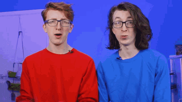 two boys wearing glasses and a red shirt are standing next to each other
