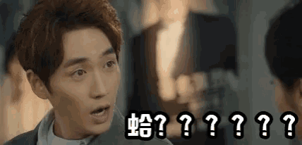 a man with a surprised look on his face is surrounded by the letters ? and ?